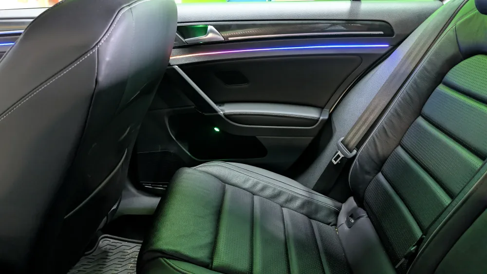 Custom RGBIC ambient lighting install along door trim and seats