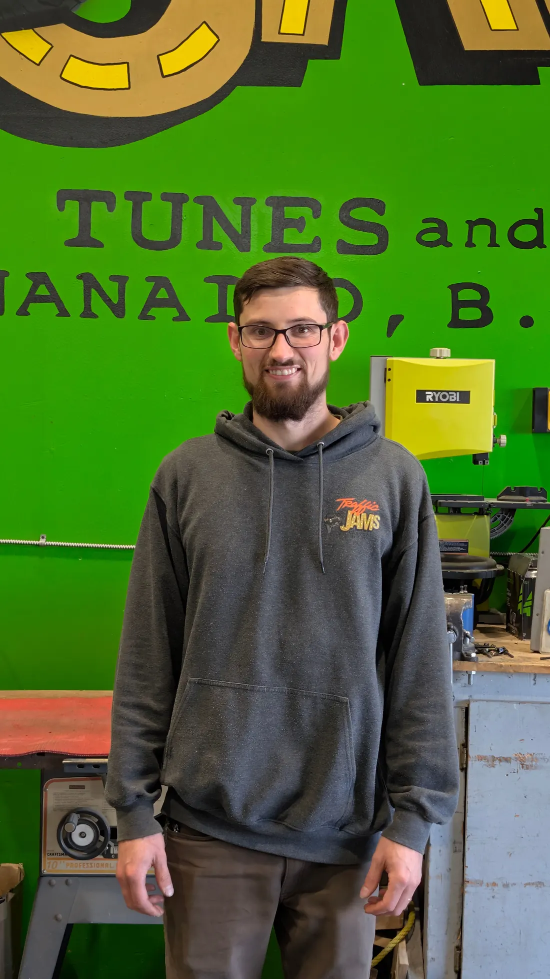 Josh Belanger, owner of Traffic Jams Car Tunes and Toys, smiling in his Nanaimo shop